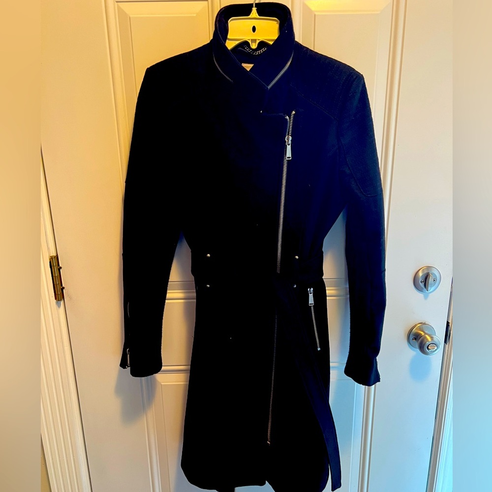 Beautiful wool coat. Trendy and elegant black coat with silver zipper